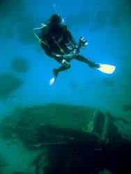 Rob looking at one of the cars from the wreck of the Xlen... by Dawn Watson 